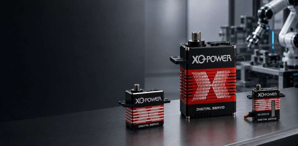 Three XQ-POWER digital servo motors in different sizes with metallic red cooling-fin casings, shown on a dark reflective surface with an industrial robotic arm in the background