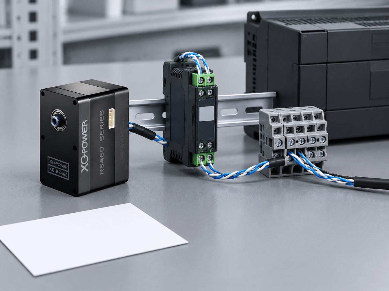 RS460 servo beside a closed controller enclosure with a differential cable pair
